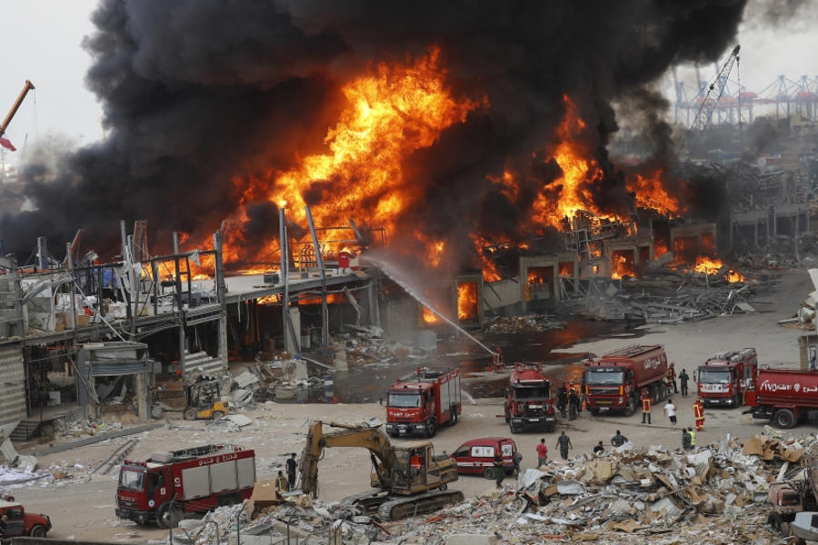 Bomberos libaneses intentan extinguir el incendio en el puerto de Beirut. EPA