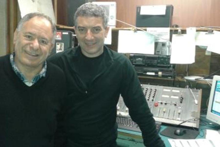 A la izquierda Julio Faiad en el estudio de radio; a su lado el programador que lo acompaña todos los domingos en su trabajo.