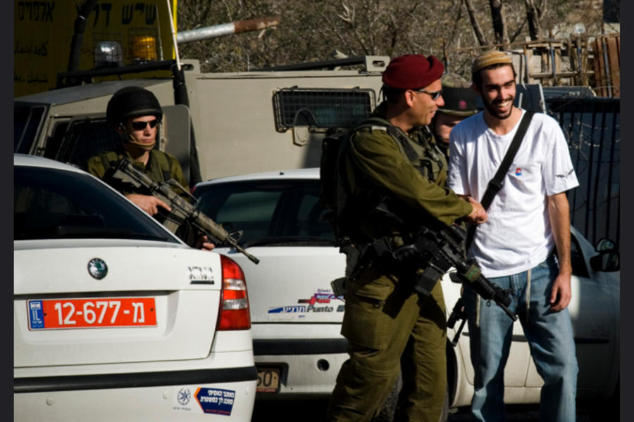 Colono israelí armado dando la mano a soldado (Foto LAntinori)